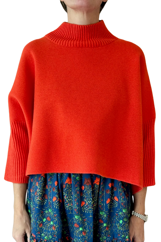 Woman in a mock neck 3/4 sleeve orange sweater
